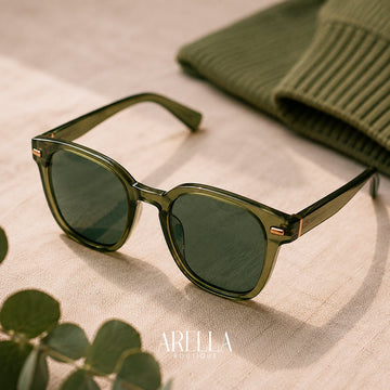 Olive green sunglasses on natural linen beside a ribbed knit