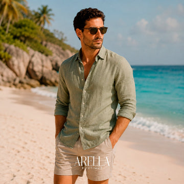 Man in a sage linen shirt and sunglasses on a tropical beach