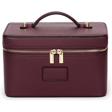 Structured vanity case in red faux leather, zipped shut with its carry handle on top