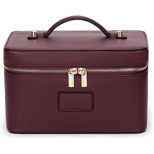 Structured vanity case in red faux leather, zipped shut with its carry handle on top