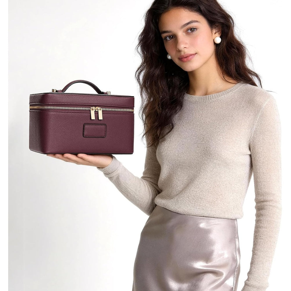 Closed vanity case carried by its top handle